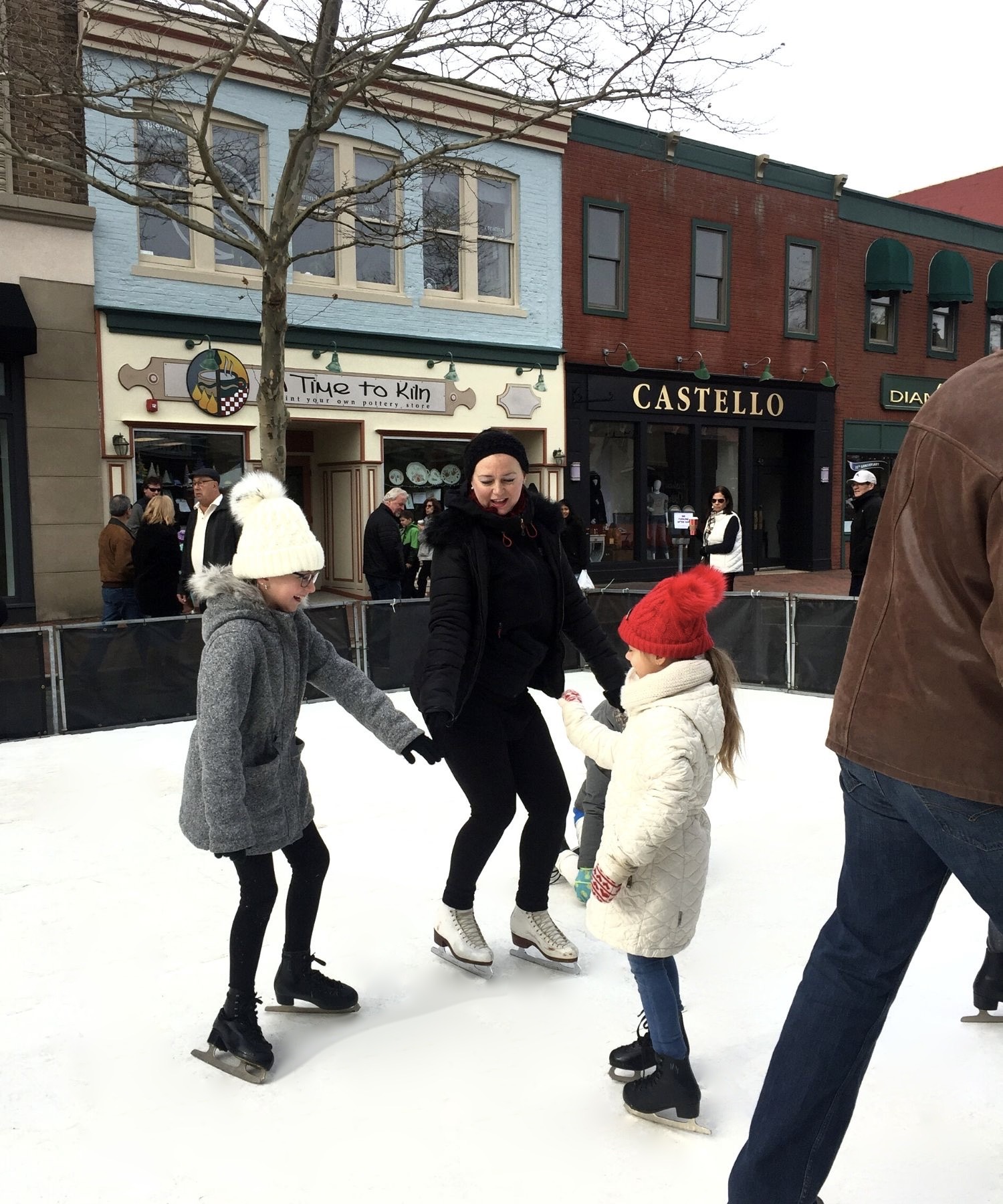 Ice skaters on main street in Red Bank, NJ on synthetic ice skating surface